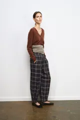 Chaqueta tipo cárdigan de lana, color beige, con escote en pico, manga larga y cierre frontal con botones.