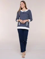 Buzo liviano de estilo deportivo-marinero y silueta semi holgada, confeccionado en tejido acanalado con diseño a rayas horizontales y verticales en azul marino y blanco. Cuenta con escote redondo amplio, cordón ajustable, bolsillo frontal tipo canguro, mangas tres cuartos con puños anchos y aberturas laterales en el ruedo.