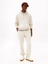 Buzo con capucha color gris claro, de corte regular, con cordón ajustable, bolsillo tipo canguro, puños y bajo de punto canalé. Logo de Tommy Hilfiger bordado en el pecho.