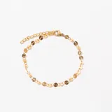 Pulsera dorada con eslabones de cadena y apliques circulares.