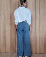 Pantalón de jean estilo wide leg con costuras verticales frontales, tiro alto y bolsillos laterales.