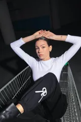 Crop top blanco de algodón con lycra, cuello redondo, manga larga y cintura con elástico afelpado con la inscripción 'RENÉE'.