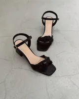 Sandalias plateadas de cuero vacuno con taco bloque de 6 cm y tira delantera con detalle de nudo.