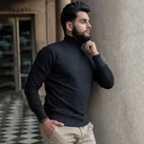 Polera de cuello alto confeccionada en tejido de algodón con spandex, de corte ajustado, con puños y ruedo acanalados.