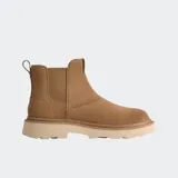 Bota tipo Chelsea de gamuza color marrón, con paneles laterales elásticos, lengüeta trasera y suela de plataforma dentada en tono crema.