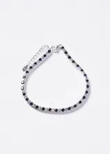 Pulsera estilo tennis de plata 925 con zirconias azules y transparentes intercaladas, y cierre de mosquetón con cadena de alargue.