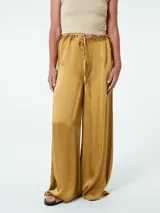 Pantalón de vestir color ocre, de corte palazzo y tiro alto, con cintura elastizada y lazo ajustable.