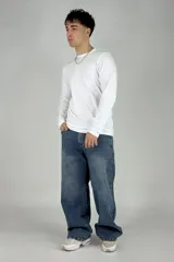 Pantalón de jean azul con efecto lavado, corte amplio, bolsillos cargo laterales y cintura baja.