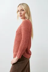 Sweater tejido de punto color rojo con cuello redondo y ruedo curvo.