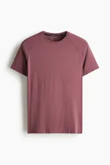 Remera deportiva de manga raglán y cuello redondo, color bordó, con diseño de tejido técnico texturizado y costuras planas, corte ajustado al cuerpo tipo muscle fit.