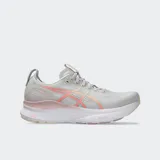 Championes de running Asics modelo Gel Kayano 32, color gris claro con detalles en coral y blanco. Presentan tecnología 4D GUIDANCE SYSTEM para estabilidad adaptativa, entresuela FF BLAST PLUS para mayor amortiguación y suela con tecnología PureGEL.