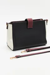 Cartera estructurada de símil cuero con diseño de bloques de color: principal en color camel, laterales en blanco y solapa frontal en negro. Posee correa larga regulable y desmontable.