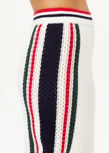 Pantalón de punto abierto de algodón orgánico color crema con rayas verticales en rojo, azul marino y verde pino. Cintura elástica acanalada con rayas de punto y silueta de pierna ancha.