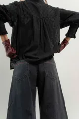 Pantalón de jean de tiro medio y pierna ancha, confeccionado en denim 100% algodón. Diseño con 5 bolsillos y pespuntes a contratono.