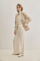 Pantalón negro de pierna ancha y calce fluido, con pinzas delanteras y bolsillos laterales.