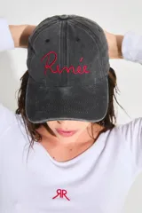 Gorra de gabardina negra con efecto lavado vintage, logo bordado en rojo en el frente y corazón bordado en la parte trasera.