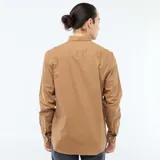 Camisa de corte regular fit en tejido oxford color marrón, con cuello abotonado y cierre frontal de botones.