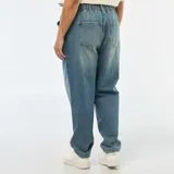 Jeans mom de color azul claro, con cintura elástica fruncida, bolsillos delanteros tipo cargo y puños elásticos en los tobillos.