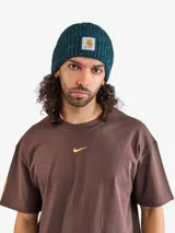 Gorro tipo beanie de tejido de punto con textura acanalada y efecto moteado multicolor. Presenta una etiqueta cuadrada con el logo de la marca en el frente.