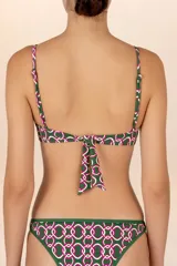 Top de bikini tipo corsetero verde oscuro con estampado geométrico de pinzas en rosa y blanco. Breteles delgados ajustables, copas con varilla y amarre en la espalda.