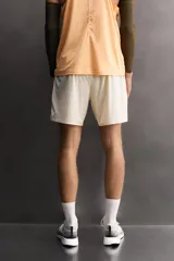 Shorts deportivos de entrenamiento Zara Athleticz, color beige, confeccionados en tejido técnico ligero y elástico con forro interior. Presentan cintura elástica ajustable, bolsillos frontales, bolsillo trasero de seguridad con cierre, aberturas laterales en el bajo y detalle de logo estampado en la pierna.