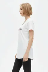 Remera negra de algodón, con cuello en V, mangas cortas, corte al cuerpo y estampa frontal con la frase "Emotionally Unavailable" en letras rosadas.