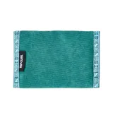 Billetera Rip Curl de tela color celeste con diseño estampado de motivos playeros y logo de la marca.