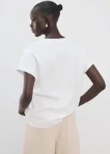 Camiseta blanca de algodón con cuello en V y mangas cortas de diseño holgado.