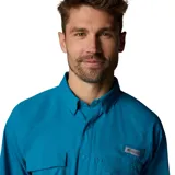 Camisa de manga larga Columbia modelo Shadowcaster Zero Ls Omni-Freeze, de color azul, diseñada para pesca con múltiples bolsillos frontales, trabilla para caña y tecnologías de protección solar y refrigeración.