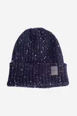 Gorro de lana azul marino con motas blancas y logo de goma en el frente.