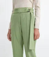 Pantalón carrot de Marfinno en color verde, confeccionado en mezcla de viscosa y lino. Presenta tiro medio, cierre frontal con cremallera, bolsillos, costuras frontales marcadas y detalle de cinturón incorporado con hebilla circular.
