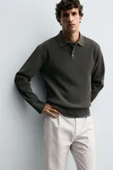Polo de punto con textura, corte regular fit, cuello solapa con cierre frontal de tres botones, manga larga y acabados en rib.