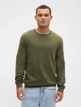 Buzo de algodón con cuello redondo, mangas largas y puños acanalados. Diseño básico y versátil de corte clásico.