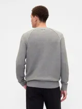 Buzo de punto de algodón con cuello redondo, mangas tipo raglán y puños y ruedo acanalados.