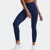 Calza deportiva 2XU modelo Form Spliced Hi-Rise de tiro alto, color azul marino con bandas laterales en contraste de tonos rosado y celeste.