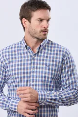 Camisa de lino y algodón con diseño a cuadros en tonos de azul, beige y blanco, de manga larga, cuello abotonado y cierre frontal con botones.