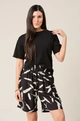 Bermuda de tiro alto, color negro con estampado de plumas blancas. Presenta cintura elástica fruncida con cordón ajustable y bolsillos laterales.