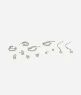 Kit de seis pares de caravanas metalizadas en diferentes formatos, incluyendo argollas pequeñas, corazones, puntos de luz y diseños alargados. Fabricadas con metal reciclado.