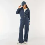 Pantalón de jogging azul de corte holgado y pernera ancha, con cintura elástica ajustable mediante cordón y bolsillos laterales.