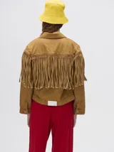 Campera de denim de algodón color negro con efecto lavado, cuello camisero, cierre frontal con botones metálicos y flecos en la parte delantera.