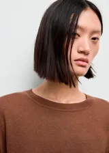 Jersey de punto fino de manga larga y cuello redondo, con diseño recto.