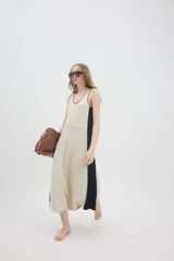 Vestido midi de punto sin mangas, con escote redondo, diseño bicolor en tonos marrón y amarillo, y corte holgado.