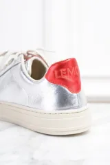 Zapatillas plateadas de cuero metalizado con estrella roja en el lateral y detalles en rojo en el talón.
