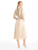 Vestido midi de satén color azul marino, con cuello alto y cintura elástica, ambos con detalle en punto smock. Presenta mangas cortas fluidas y falda plisada con caída ligera.
