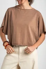 Remera oversize de algodón blanco crudo, con cuello redondo y mangas cortas anchas de corte relajado.
