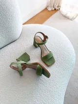 Sandalias de gamuza color verde pistacho, con tira frontal ancha, tira al tobillo con hebilla ajustable y taco cuadrado mediano.