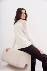 Remera negra de manga larga con detalle de encaje en hombros y espalda.