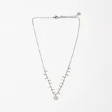 Colgante de cadena fina de acero con múltiples dijes pequeños en forma de barra y un dije central circular con cristal engastado.