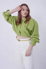 Camisa verde de mangas largas abullonadas, con cuello clásico y cierre frontal con botones.