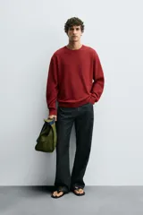 Jersey de hombre color borgoña, de corte holgado, tejido en hilatura con mezcla de algodón. Cuello redondo y manga larga. Acabados en rib.